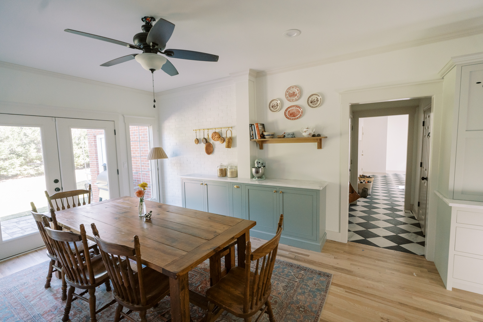 Devol inspired complete kitchen renovation with blue cabinets and marble checkerboard floors.