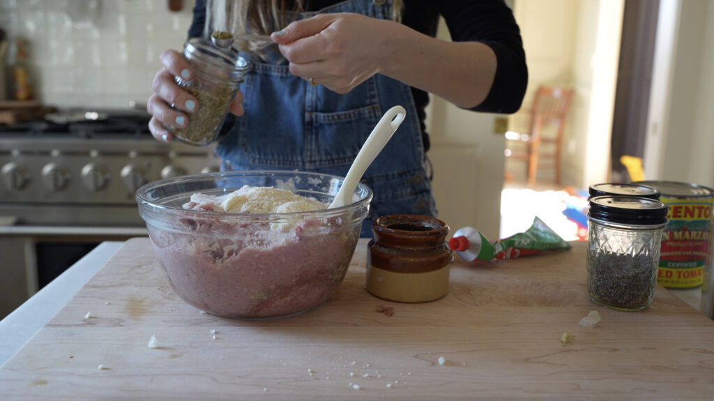 mixing a big bowl of slow cooker meatballs to feed a crowd