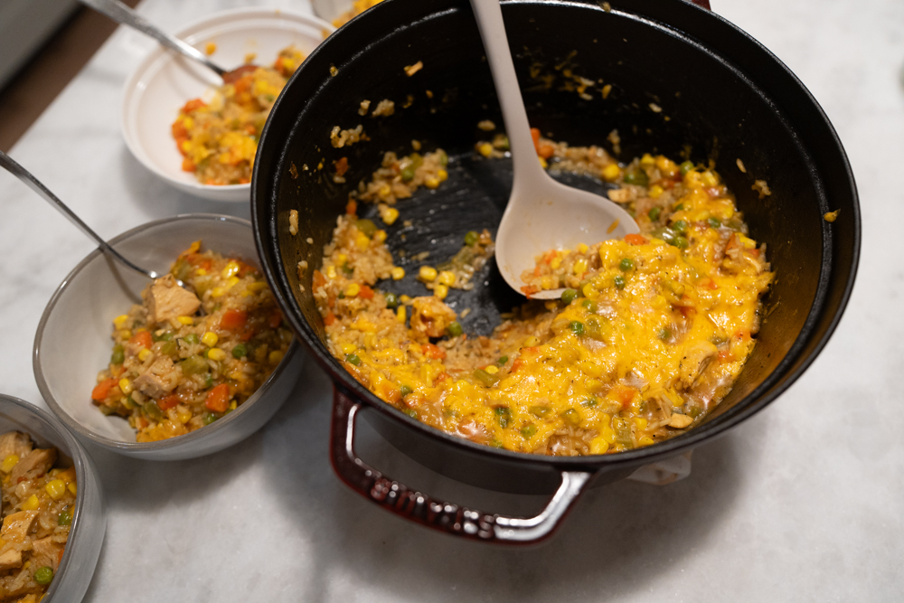 Chicken Pot Pie Rice Skillet in a pot with serving bowls on the counter