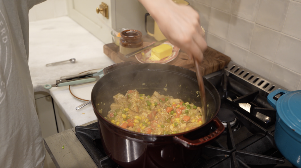 woman mixing rice skillet meal in a pot