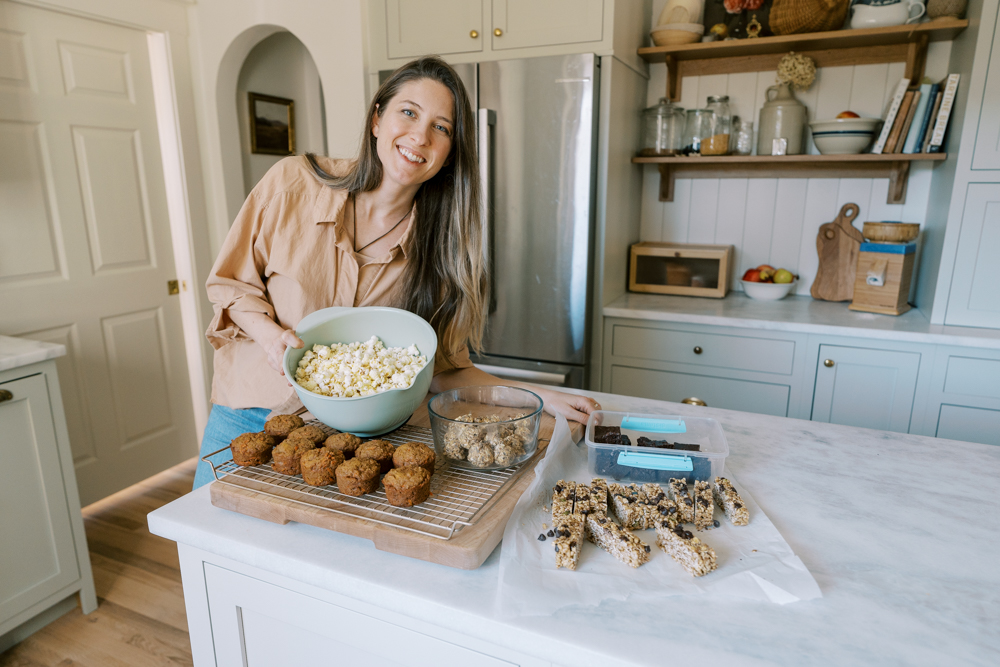 lady showing off lots of homemade snacks on the kitchen counter