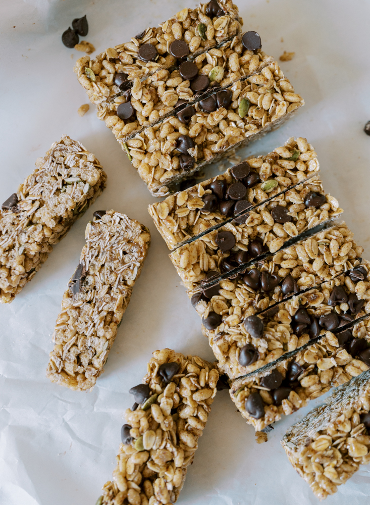 homemade chewy granola bars on parchment paper on the counter