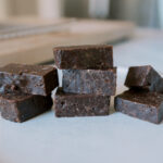 fudgy snack bars made with pecans and walnuts sitting on a plate