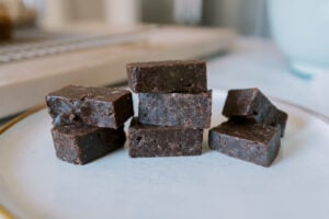fudgy snack bars made with pecans and walnuts sitting on a plate