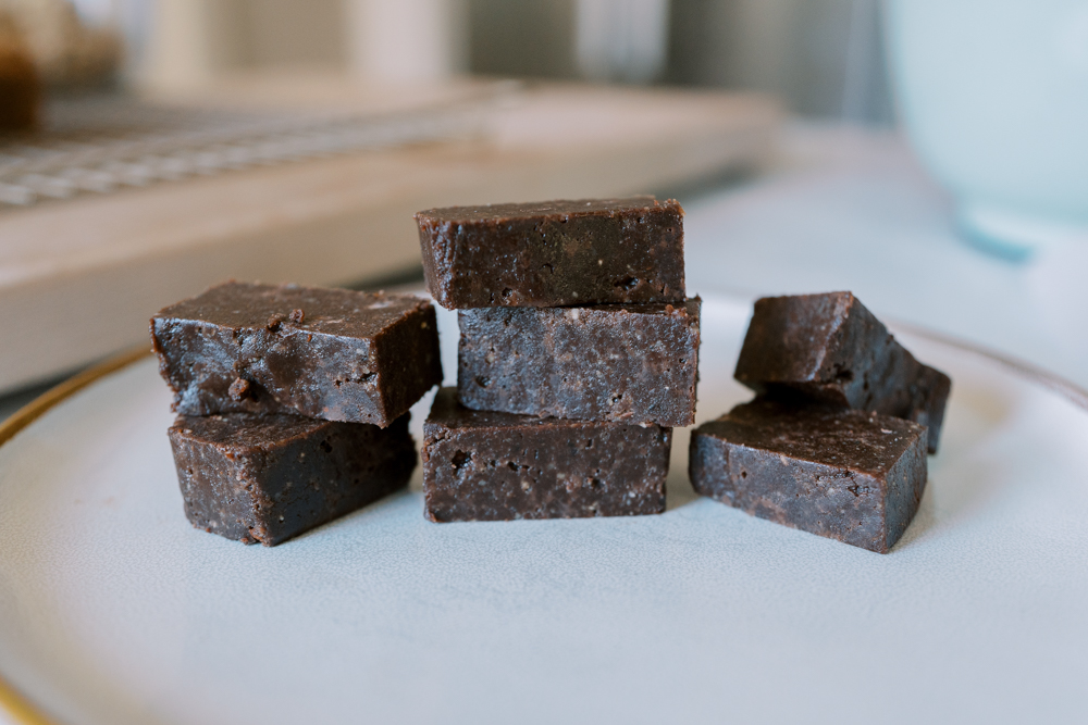 fudgy snack bars made with pecans and walnuts sitting on a plate