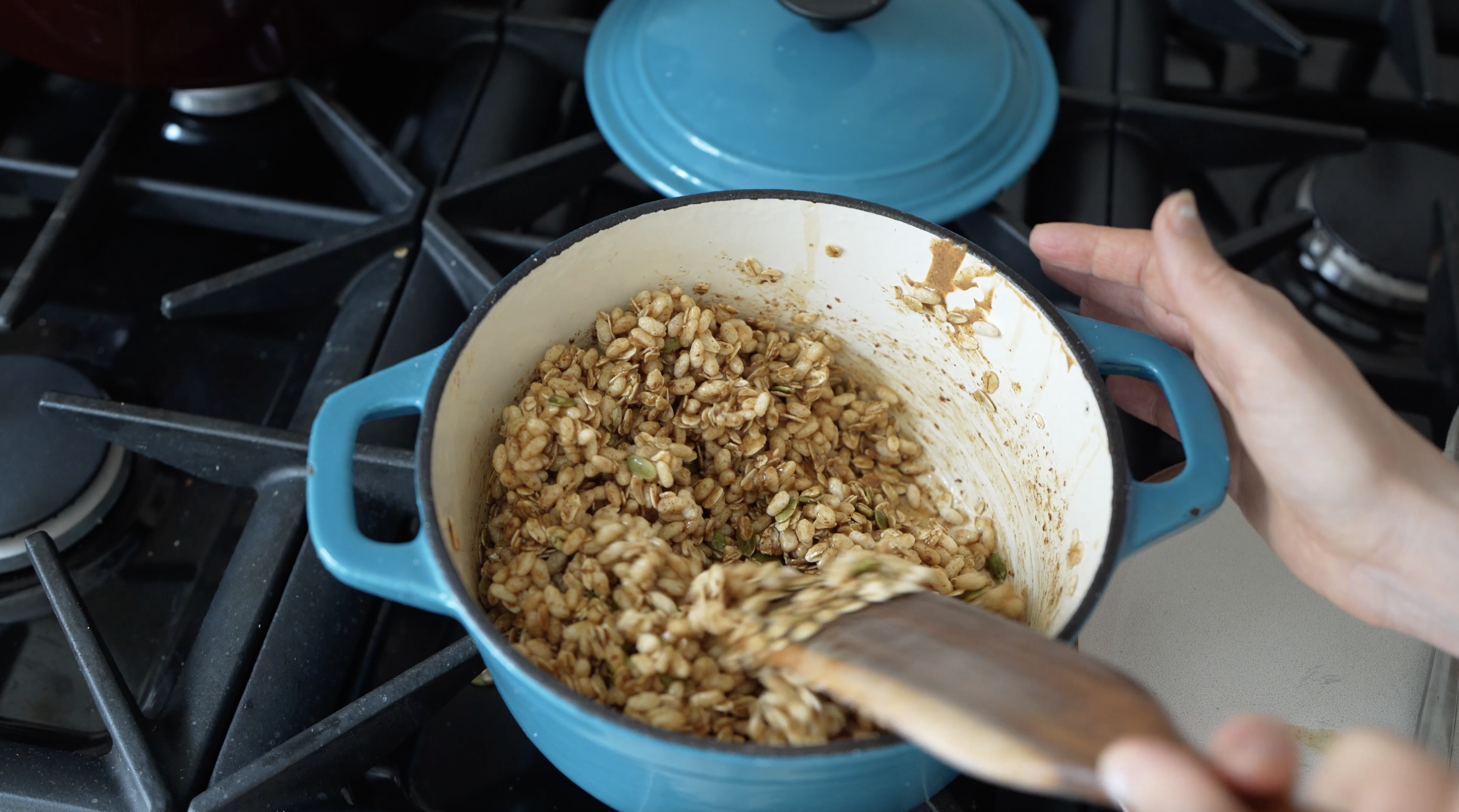 oats mixed up in a hot pan for no bake granola bars