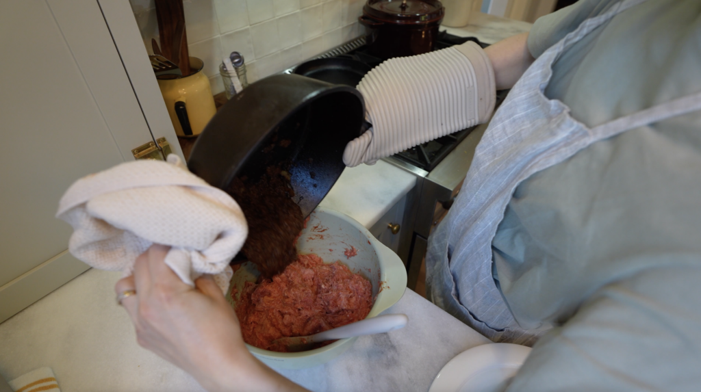 woman mixing together healthy meatloaf mixture in a bowl