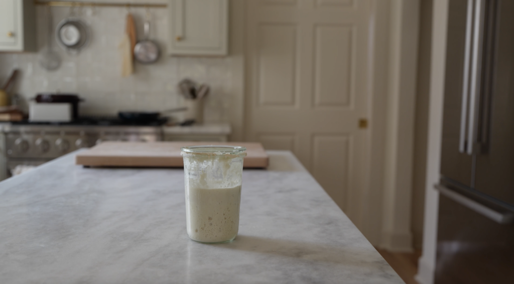 sourdough starter in a weck jar sitting out on a beautiful kitchen counter