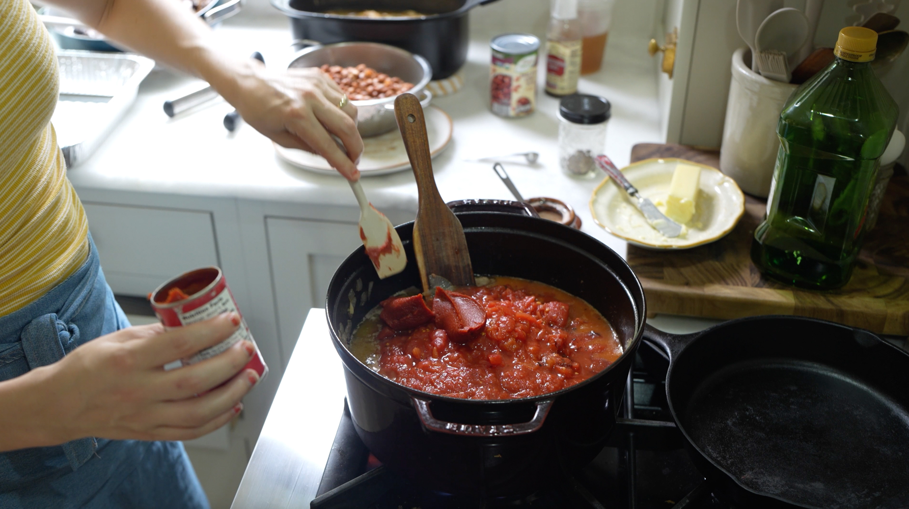 Tomato paste being stirred into chili