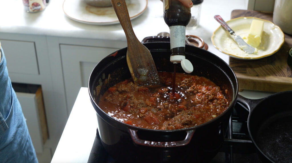 adding flavor boosters to simmering chili