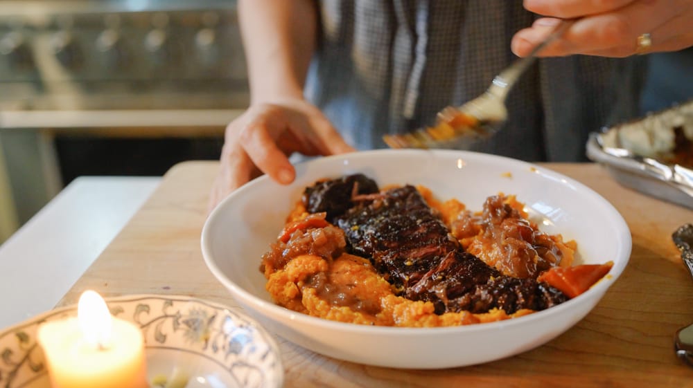 a cozy dinner and lit candle