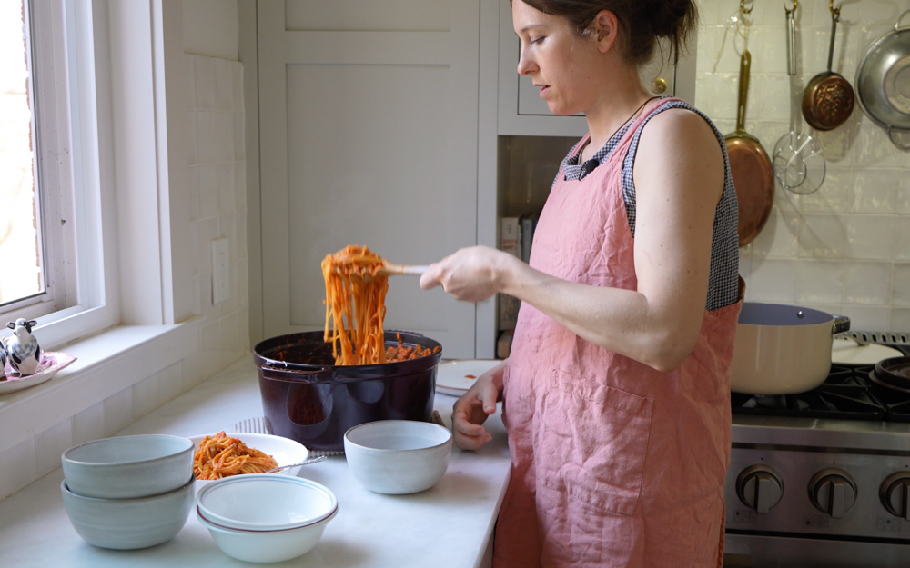 woman serving spaghetti