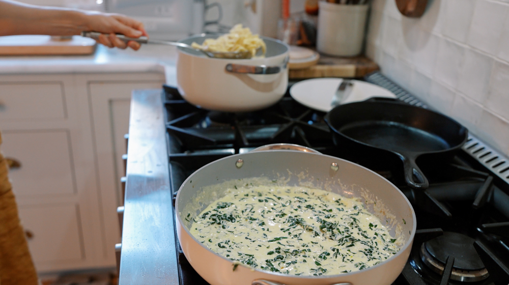 alfredo sauce simmering in a skillet