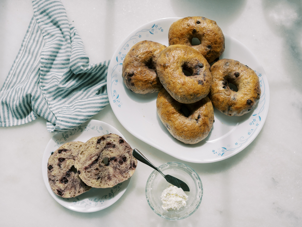 a plate of fresh homemade sourdough blueberry bagels