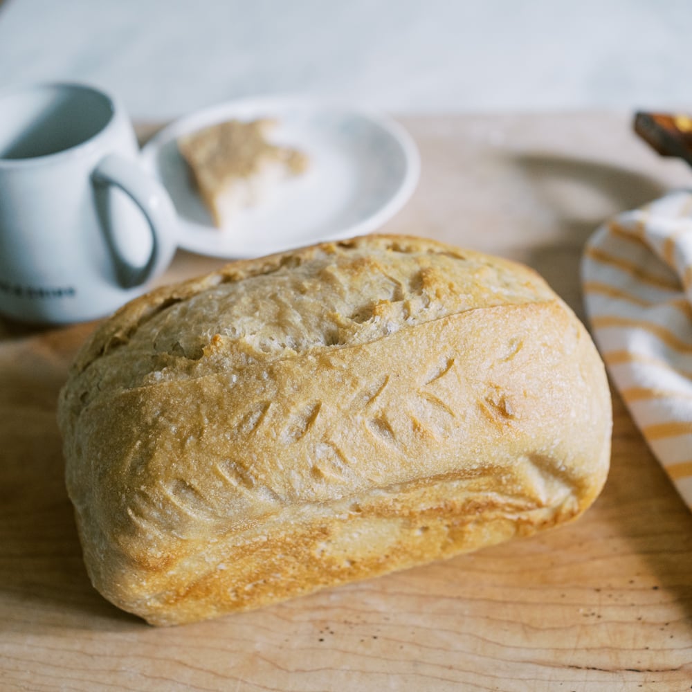 crusty sourdough bread baked in a loaf pan